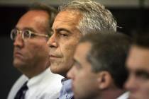 FILE - In this July 30, 2008 file photo, Jeffrey Epstein, center, is shown in custody in West P ...