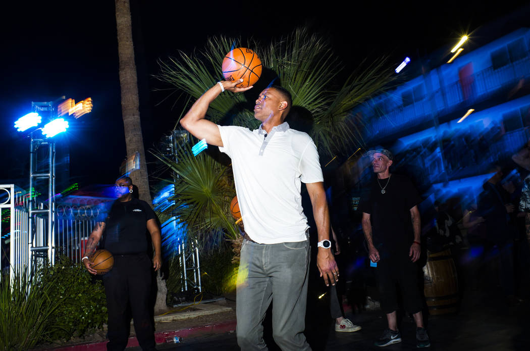 Former NBA player Allan Houston, center, shoots a basket during the Jack Daniel's House No. 7, ...