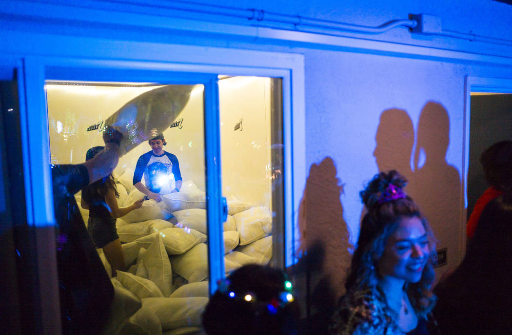 Attendees participate in a pillow fight during the Jack Daniel's House No. 7, a pop-up experien ...