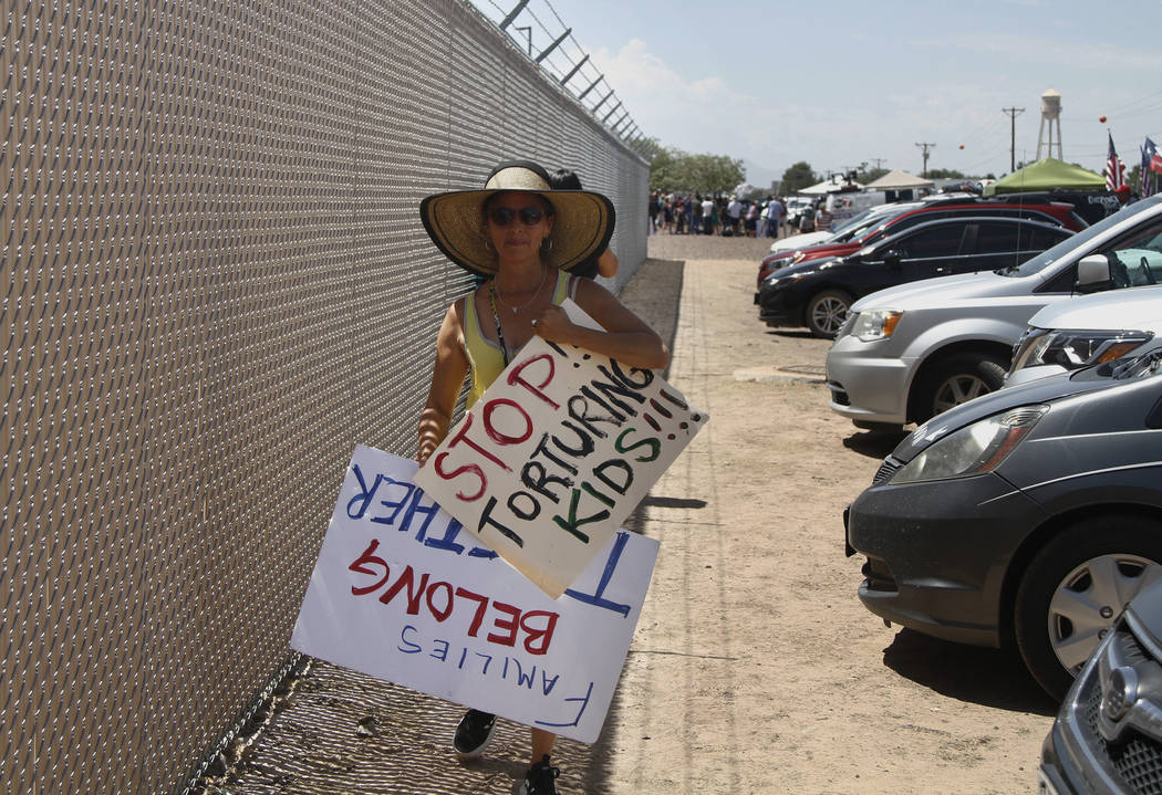 A grandmother protesting the treatment of children in Border Patrol custody walks back to her c ...