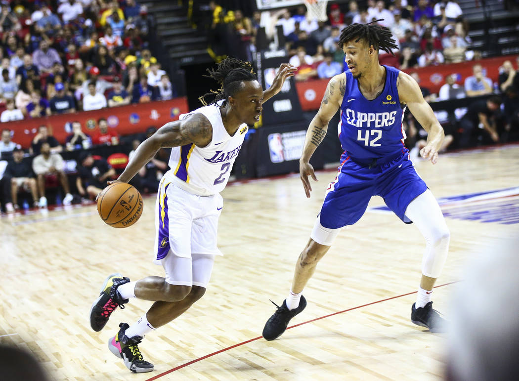 Los Angeles Lakers' Jaron Johnson (2) drives the ball against Los Angeles Clippers' Amir Coffey ...