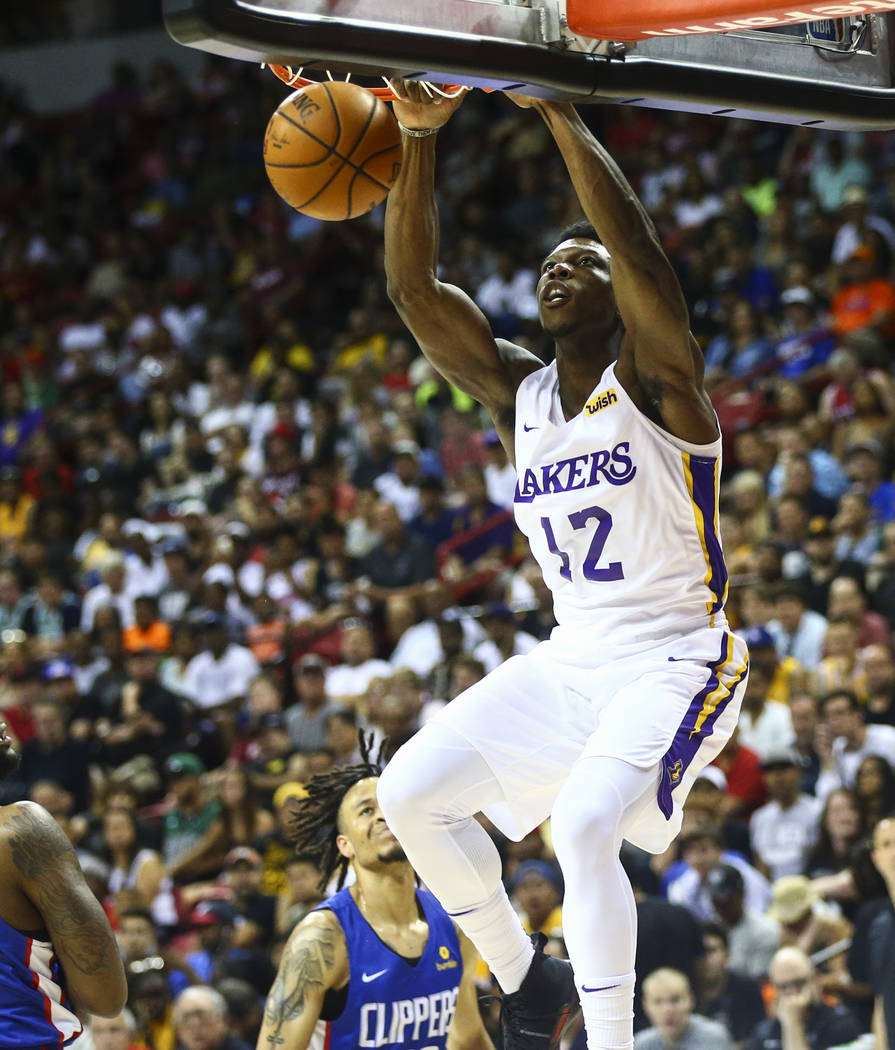 Los Angeles Lakers' Devontae Cacok (12) dunks against the Los Angeles Clippers during the first ...