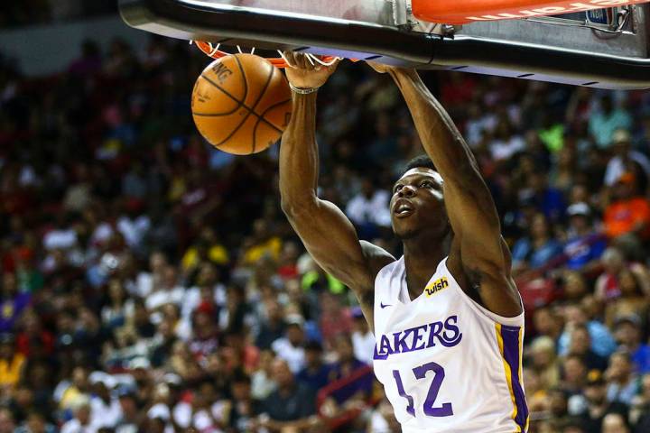 Los Angeles Lakers' Devontae Cacok (12) dunks against the Los Angeles Clippers during the first ...