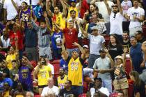 Basketball fans cheer for free items during a game between the Los Angeles Lakers and the Los A ...