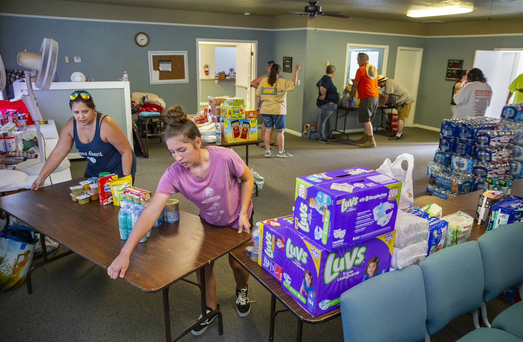 Julia Doss, left, president of the Trona Care, a local community group, and others work to coor ...