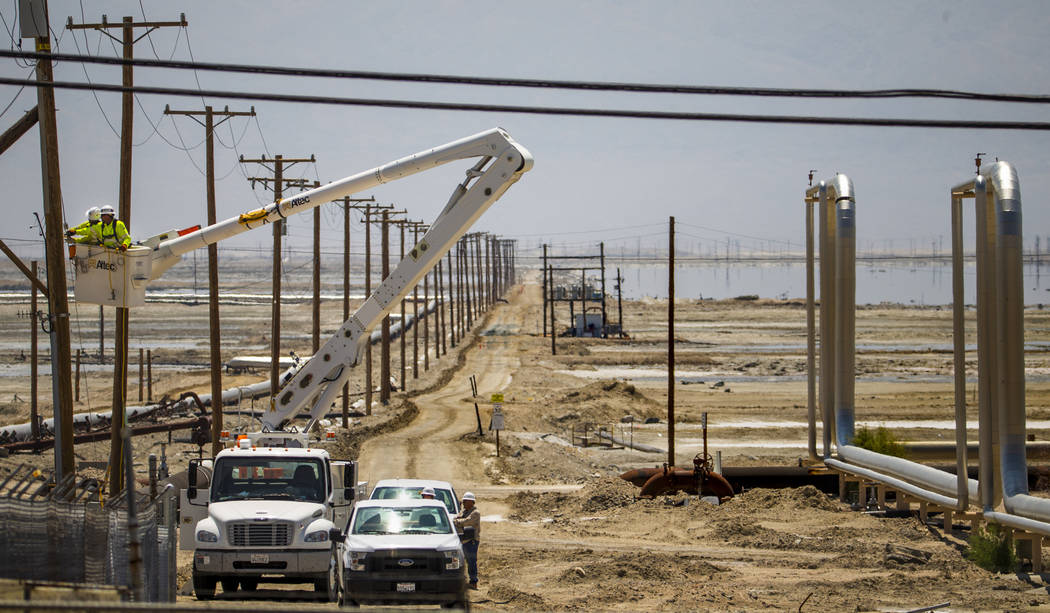 A Southern California Edison crew works to repair the power lines near the Searles Valley Miner ...