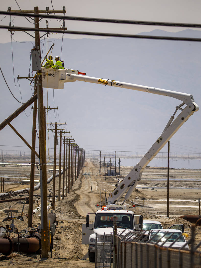 A Southern California Edison crew works to repair the power lines near the Searles Valley Miner ...