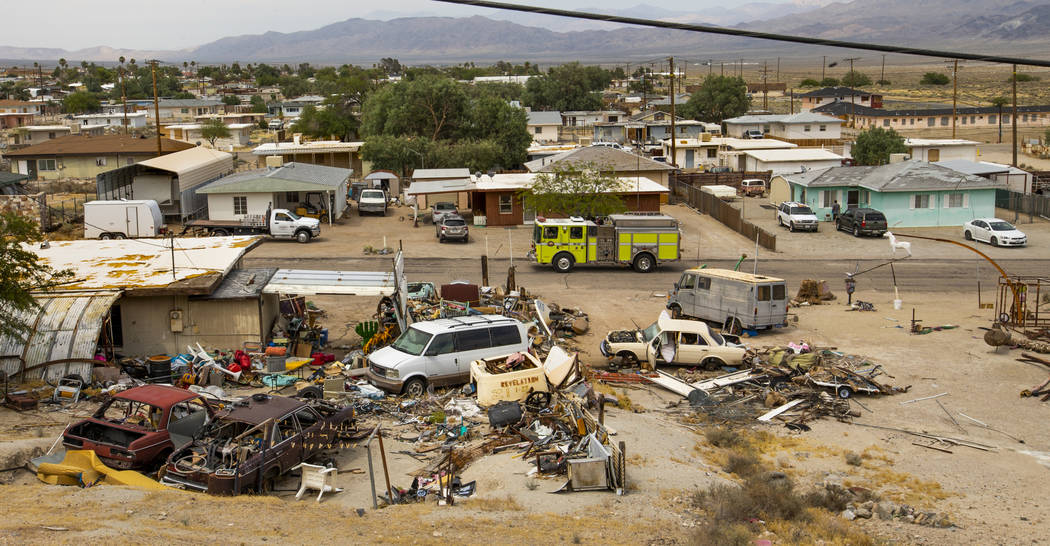 A fire engine crew patrols the numerous homes about the Pioneer Point neighborhood which have s ...