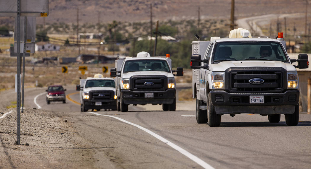 Utility repair vehicles roll into Trona, Calif., as water and electricity services are currentl ...
