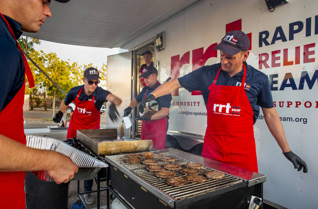 Members of a Red Cross Rapid Relief Team prepare to serve hamburgers to clients at the Ridgecre ...