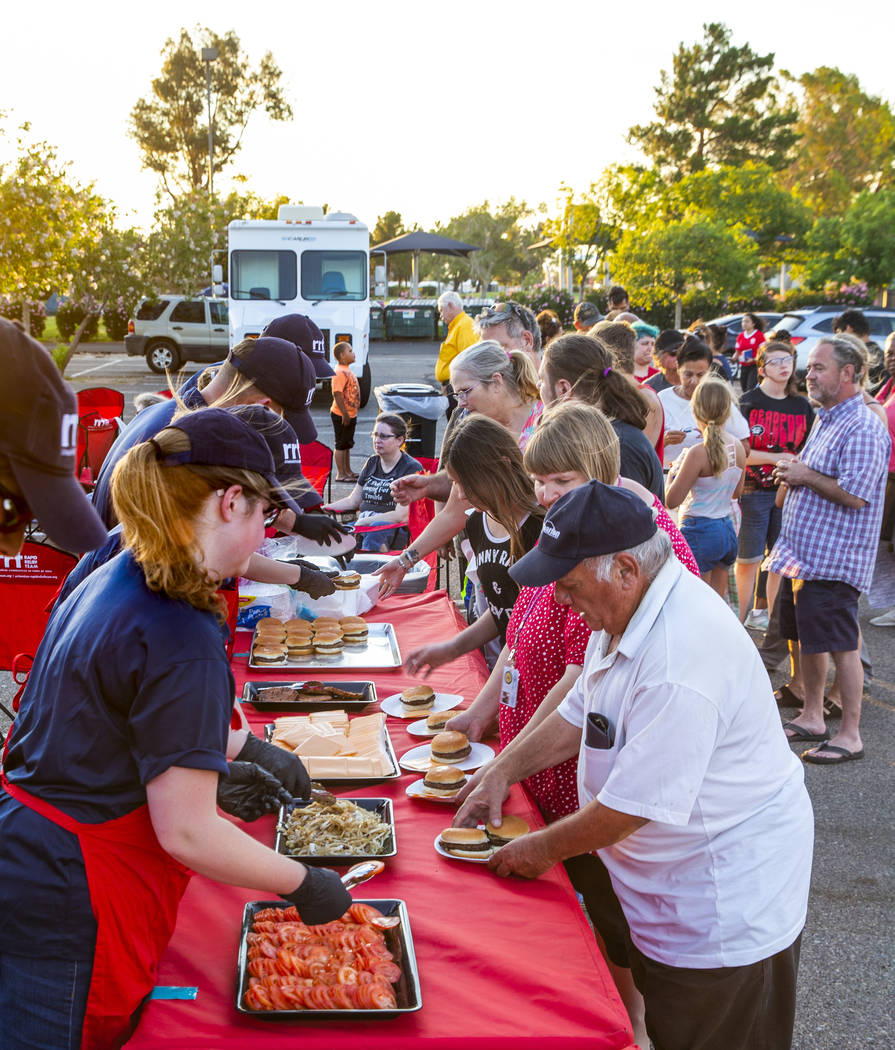 Members of a Red Cross Rapid Relief Team serve hamburgers to clients at the Ridgecrest Communit ...