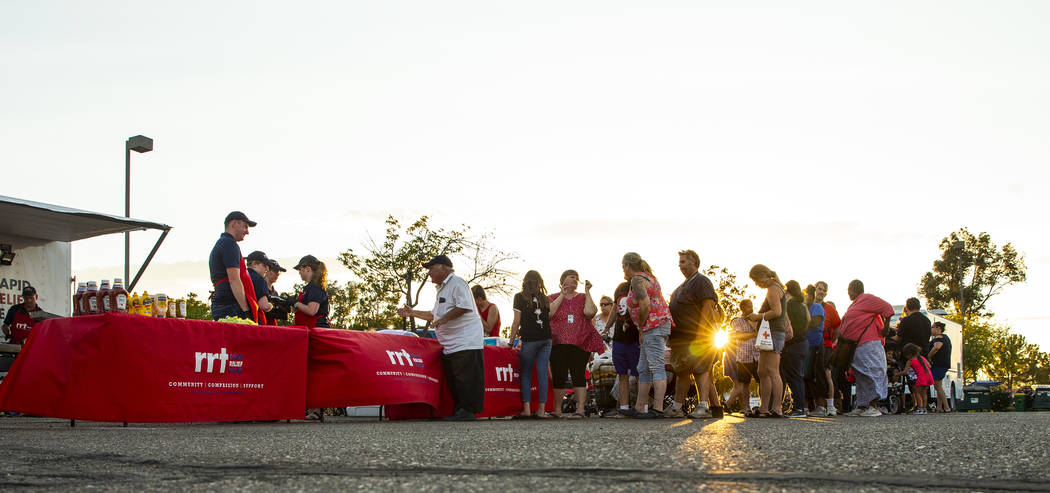 Members of a Red Cross Rapid Relief Team serve hamburgers to clients at the Ridgecrest Communit ...