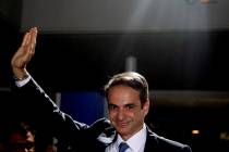 Greek opposition New Democracy conservative party leader Kyriakos Mitsotakis waves to his suppo ...