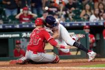 Houston Astros' Jake Marisnick, right, collides Los Angeles Angels catcher Jonathan Lucroy (20) ...