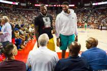 Los Angeles Lakers' LeBron James and Anthony Davis talk with Jerry West, of the Clippers, seate ...