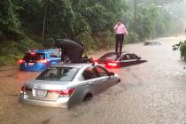 Motorists are stranded on a flooded section of Canal Road in Washington during a heavy rainstor ...