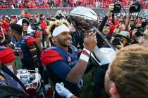 Fresno State quarterback Marcus McMaryion raises the trophy in celebration of his team's win ov ...