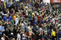Fans cheer for their team during the Vegas Summer League game between the Washington Wizard the ...