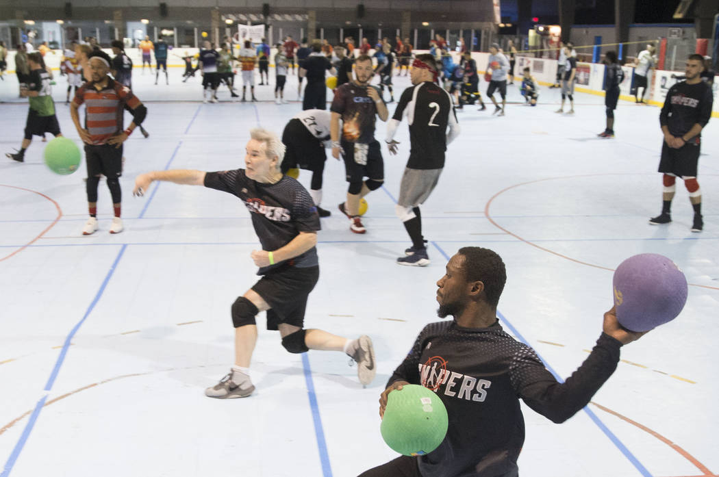 Joe Grant, bottom right, of team Snipers attacks during a two-day, five-division dodgeball tour ...
