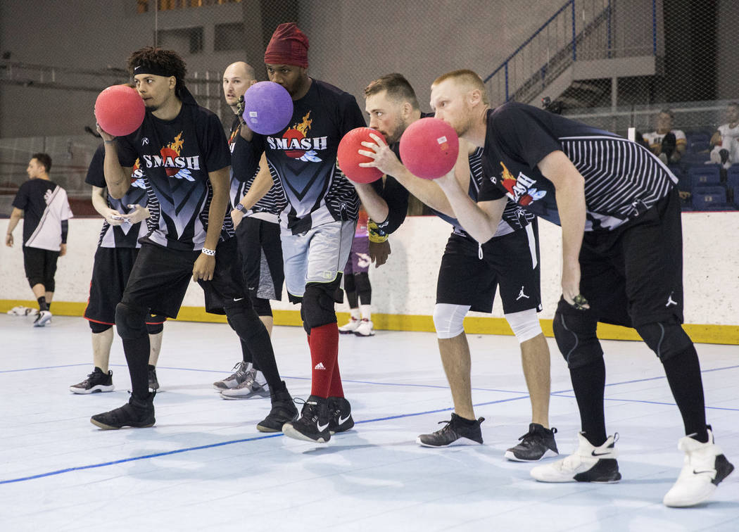 Team Smash huddles up before attacking during a two-day, five-division dodgeball tournament on ...