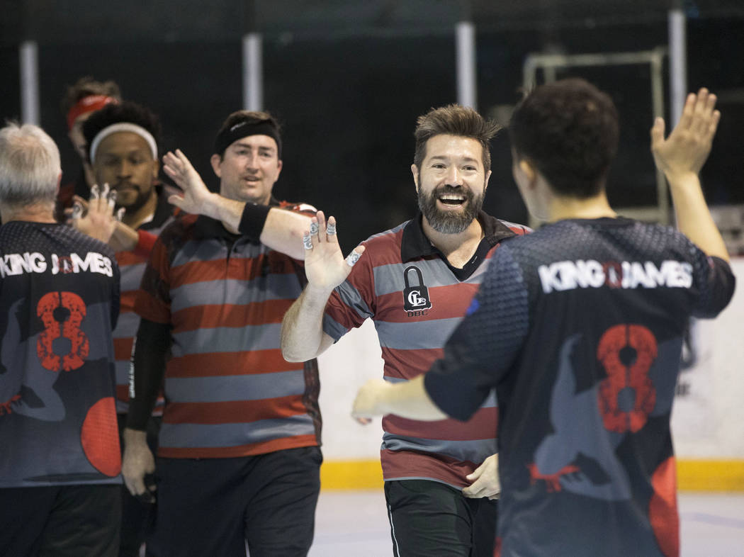 Jake Mason, right/facing, celebrates with team Gridlock during a two-day, five-division dodgeb ...