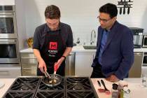 Memphis Meats CEO Uma Valeti, right, watches chicken produced in a laboratory from chicken cell ...