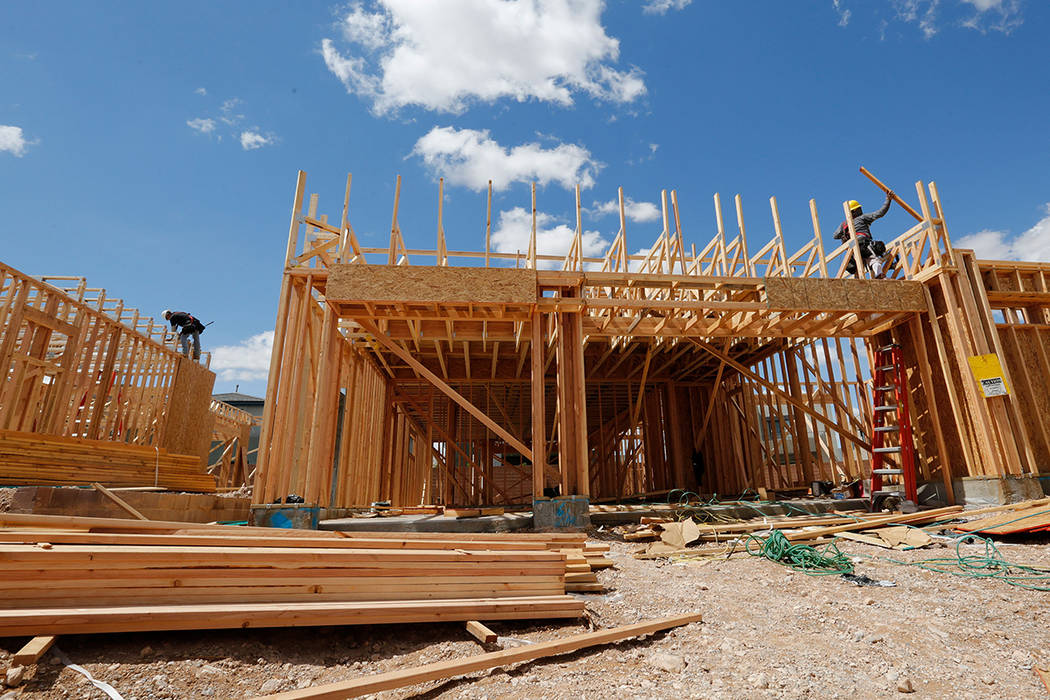 Workers construct houses near the corner of Mesa Park Drive and Hualapai Way in Summerlin, Frid ...
