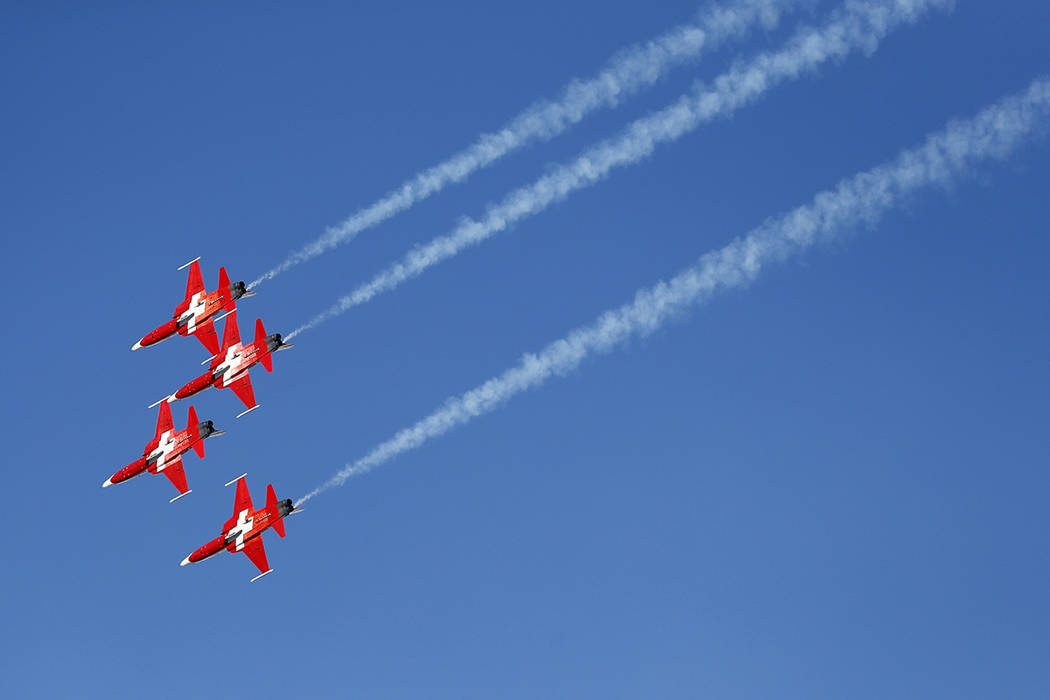 The Patrouille Suisse, an aerobatic team of the Swiss Air Force, flies past ahead of an alpine ...