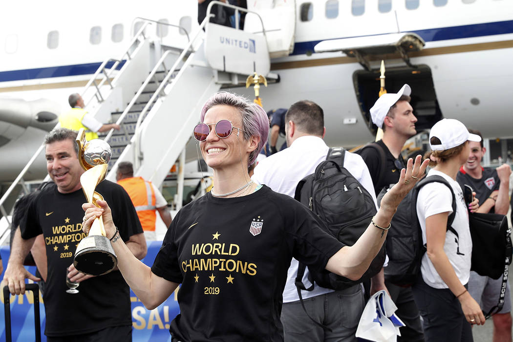 United States women's soccer team member Megan Rapinoe holds the Women's World Cup trophy after ...