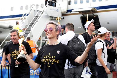 United States women's soccer team member Megan Rapinoe holds the Women's World Cup trophy after ...