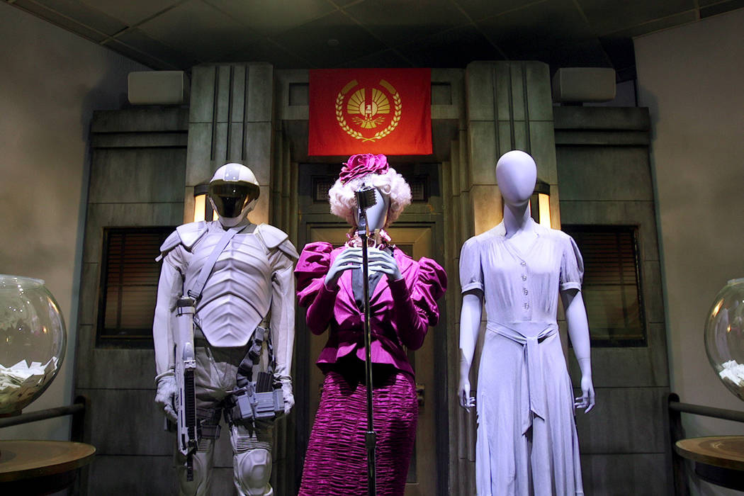 Costumes that were worn by Elizabeth Banks (center), Jennifer Lawrence (right) and other cast o ...