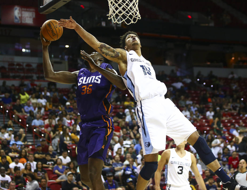 Memphis Grizzlies' Brandon Clarke (15) goes for a rebound against Phoenix Suns' Landry Nnoko (3 ...