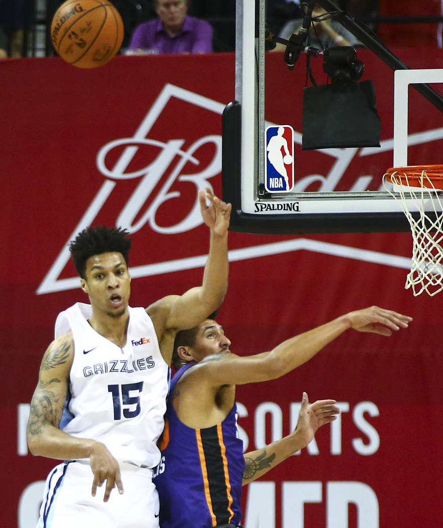 Memphis Grizzlies' Brandon Clarke (15) jumps for a rebound against Phoenix Suns' Derek Willis d ...