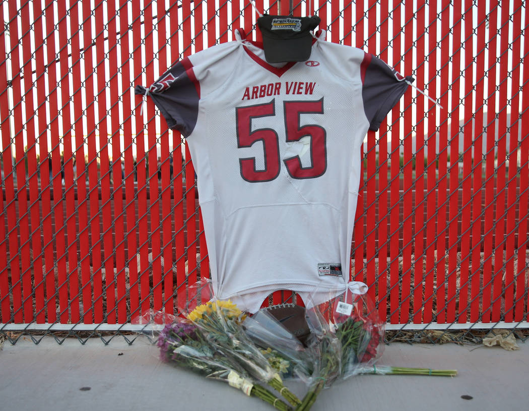 A memorial outside the Arbor View High School football field during a vigil for Malik Noshi, a ...