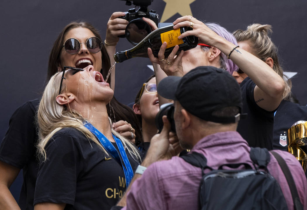 ADDS ID OF PLAYER ALLIE LONG - U.S. women's soccer team player Megan Rapinoe pours champagne fo ...
