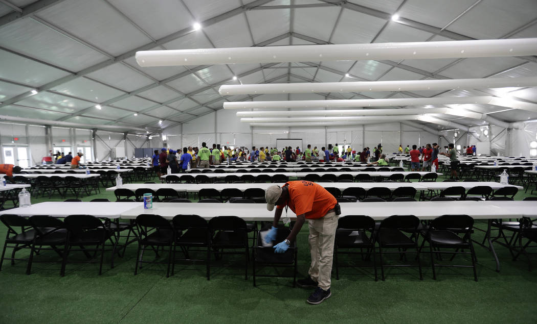 In this July 9, 2019, photo, a staff member cleans in a dinning hall at the U.S. government's n ...