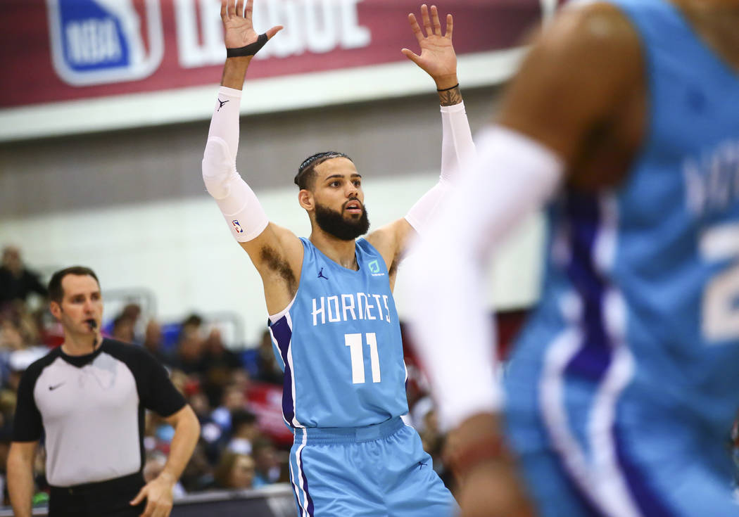 Charlotte Hornets' Cody Martin (11) motions to teammates during the second half of a basketball ...