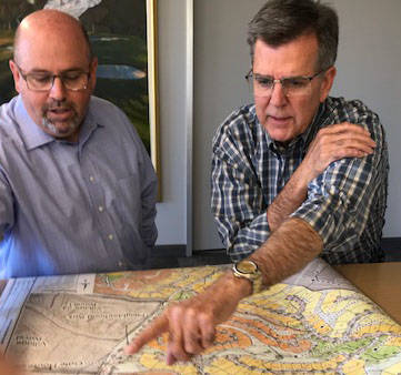 Howard Hughes Corp. executives Andy Ciarrocchi, left, and Tom Warden view map of properties bei ...