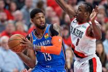 In this April 16, 2019, file photo, Oklahoma City Thunder forward Paul George, left, looks to p ...