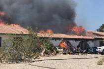 Crews battle a house fire Thursday, July 11, 2019, on the 5300 block of North Fort Apache Road ...