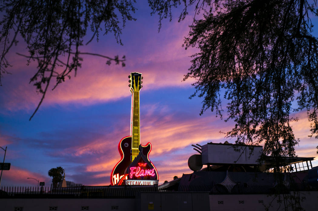 A view of the Hard Rock Cafe guitar and The Flame signs at the Neon Museum in downtown Las Vega ...
