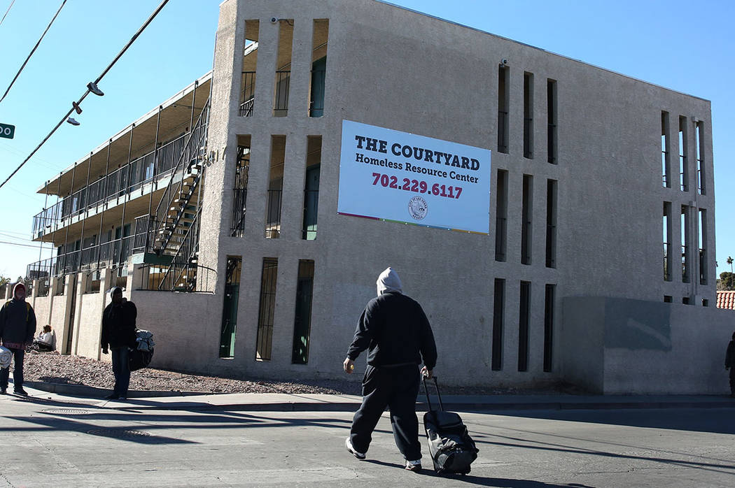 Pedestrians walk past the city of Las Vegas’ homeless courtyard on Tuesday, Jan. 22, 201 ...