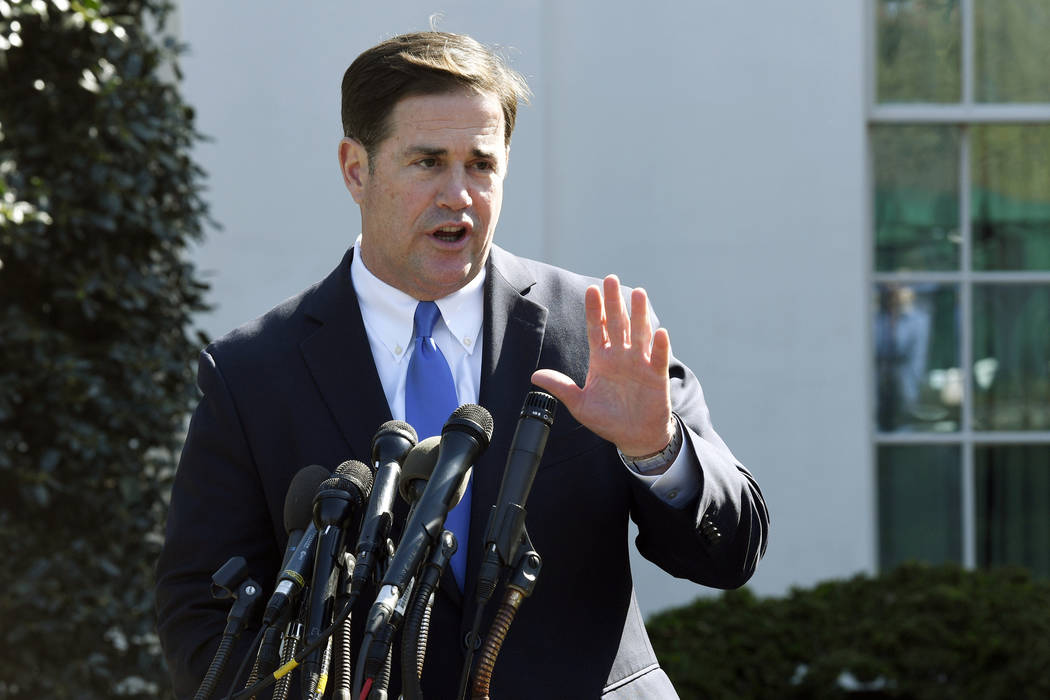 FILE - In this April 3, 2019, file photo, Arizona Gov. Doug Ducey talks to reporters outside th ...