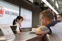 Andrew Szucs, right, who was on the Air Canada flight that made an emergency landing, waits for ...