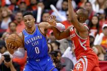 Oklahoma City Thunder guard Russell Westbrook (0) is fouled by Houston Rockets guard Chris Paul ...