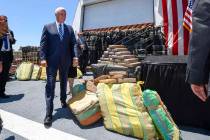 Vice President Mike Pence walks past bales of seized cocaine during a visit to the U.S. Coast G ...