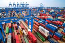 In a Tuesday, May 14, 2019, photo, containers are piled up at a port in Qingdao in east China's ...