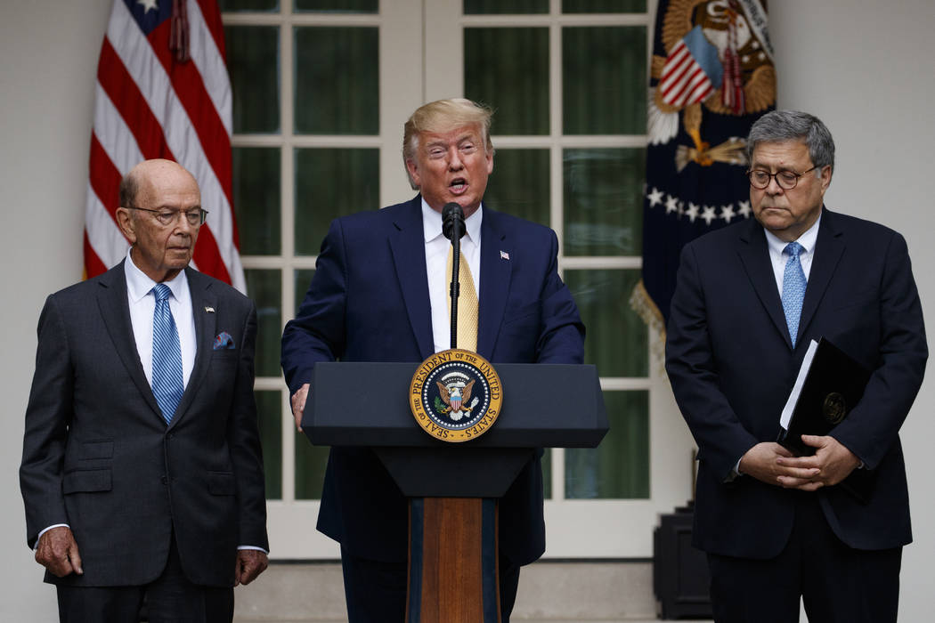 President Donald Trump, joined by Commerce Secretary Wilbur Ross, left, and Attorney General Wi ...