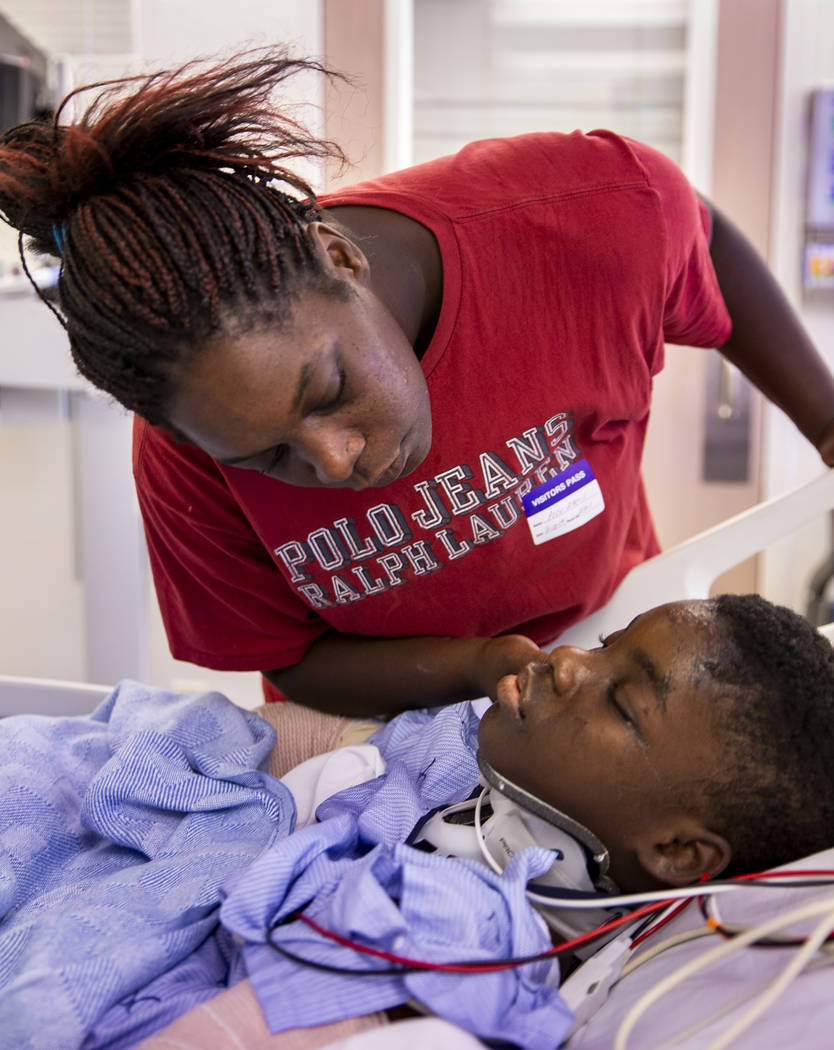 Thylicia McKnight, above, attempts to wake her son Lennie Modica, 9, who is in recovery in the ...