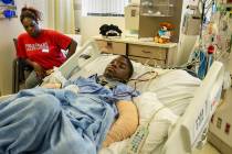 Lennie Modica, 9, right, sleeps as his mother Thylicia McKnight stays with him during recovery ...